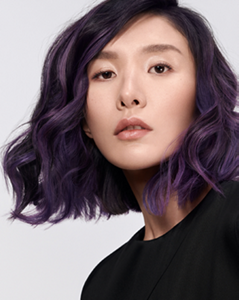 Young woman with pink hair and grey background