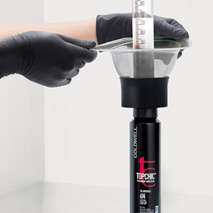 Hands with gloves holding TOPCHIC color and lotion depot system