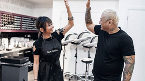 Hair stylists doing high five in a salon