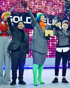 Creative award winner on stage showing proudly their awards