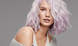 Young woman with pink hair and grey background