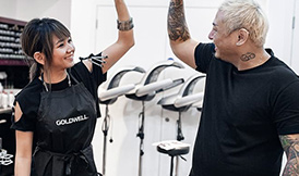 Hair stylists doing high five in a salon