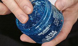 Hands holding Goldwell product Ultra Volume