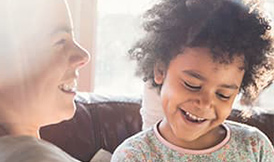 Mom reading a book to her kids