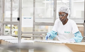 Woman wearing safety clothes and working on packages