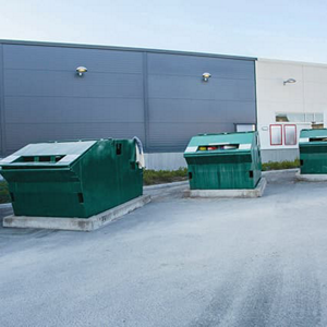 Green waste containers in yard and hall in background