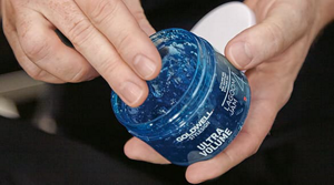 Hands holding Goldwell product Ultra Volume