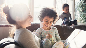 Mom reading a book to her kids