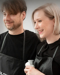 Male and female stylist partners hugging and smiling