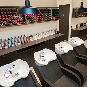 Hair salon with sinks in a row and hair products in background