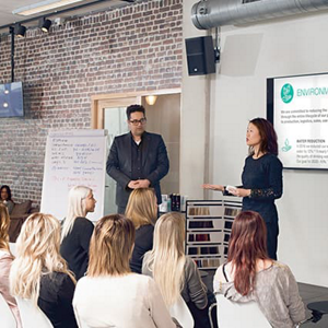 Many hair stylists at an educational training