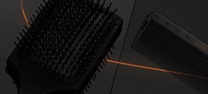 Black VARIS paddle hair brush bristles in front of a dark background