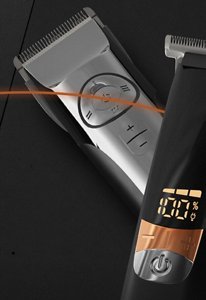 Silver VARIS clipper and black VARIS trimmer in front of a dark background