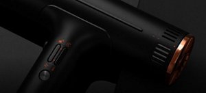 Black VARIS AIRQ hair dryer in front of a dark background