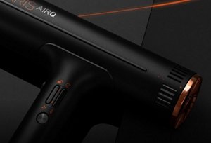 Black VARIS AIRQ hair dryer in front of a dark background