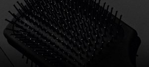 Black VARIS brush in front of a dark background