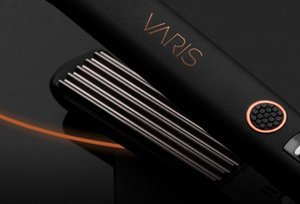 Black VARIS crimper in front of a dark background